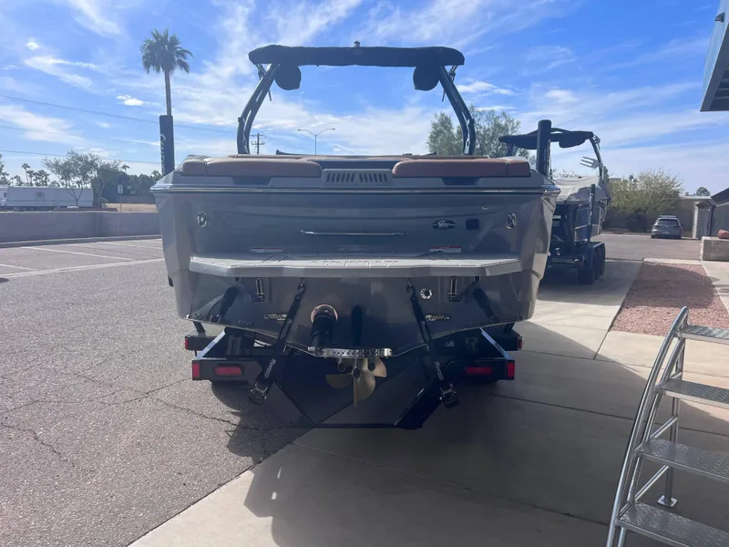 Slide: The Image of 2025 Supreme S240 boat rear view in sunny outdoor setting. - 3