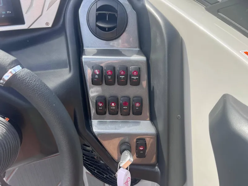 Slide: The Image of Control panel of 2025 Supreme S240 boat with labeled switches and key ignition. - 8