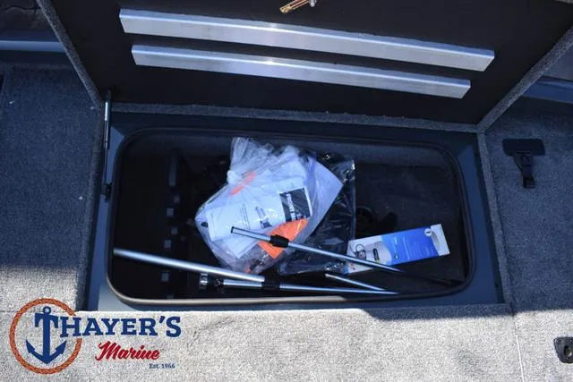 Slide: The Image of Storage compartment of 2025 Ranger RT198P boat with equipment and Thayer's Marine logo. - 14