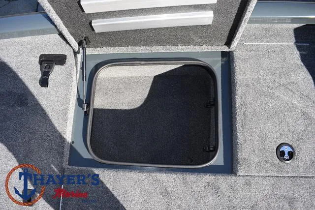 Slide: The Image of 2025 Ranger RT198P boat storage compartment with carpeted interior and latch. - 15