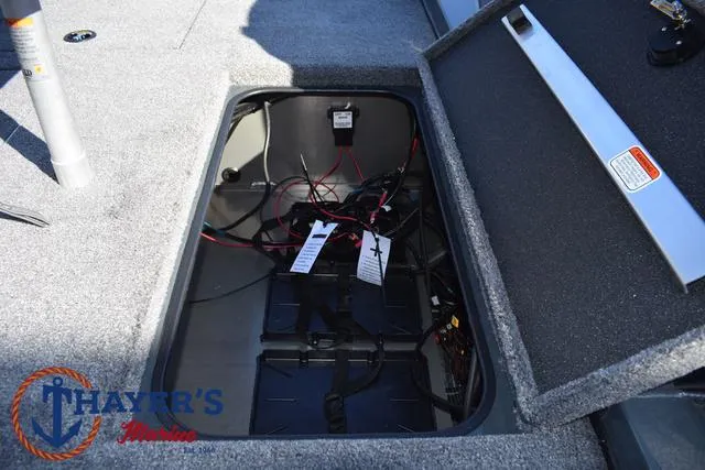 Slide: The Image of 2025 Ranger RT198P boat battery compartment with wiring and storage. - 32