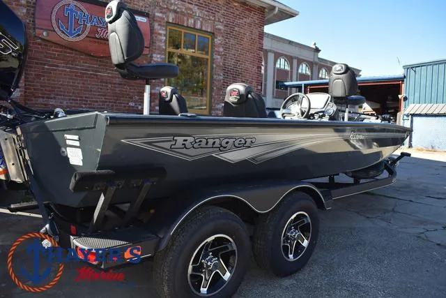 Slide: The Image of 2025 Ranger RT198P boat with dual axles parked outside a brick building. - 39
