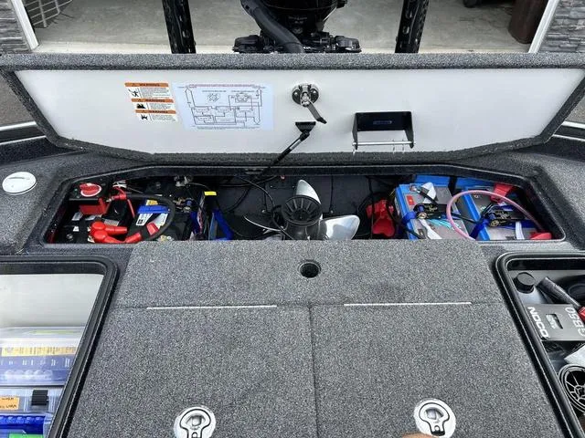 Slide: The Image of 2023 Ranger Z520R boat storage compartment with organized equipment and battery setup. - 10