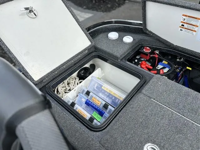 Slide: The Image of 2023 Ranger Z520R boat storage compartment with organized tackle boxes and equipment. - 11