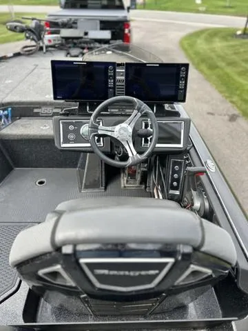 Slide: The Image of 2023 Ranger Z520R boat cockpit with dual screens and steering wheel. - 12