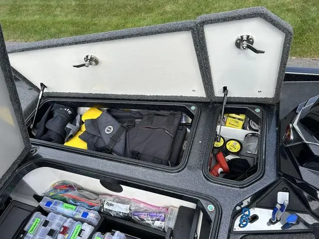 Slide: The Image of 2023 Ranger Z520R storage compartments with fishing gear and accessories. - 16