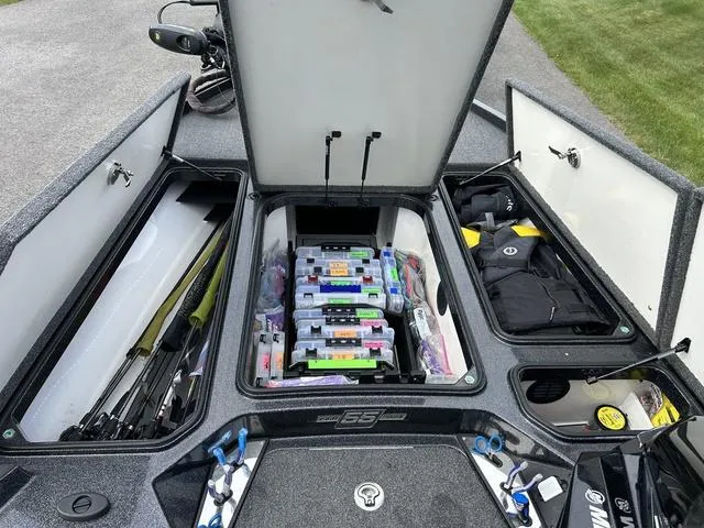 Slide: The Image of 2023 Ranger Z520R boat storage compartments with fishing gear and tackle boxes. - 19