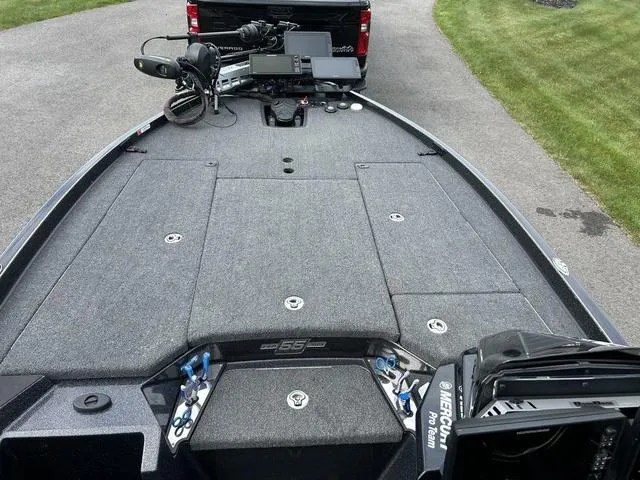 Slide: The Image of 2023 Ranger Z520R fishing boat deck with equipment, parked on a driveway. - 22