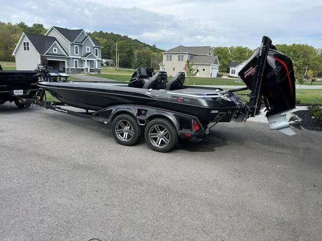 Slide: The Image of 2023 Ranger Z520R boat on trailer, parked in suburban neighborhood. - 24