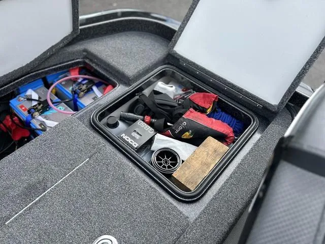 Slide: The Image of 2023 Ranger Z520R boat storage compartment with various gear and accessories. - 9