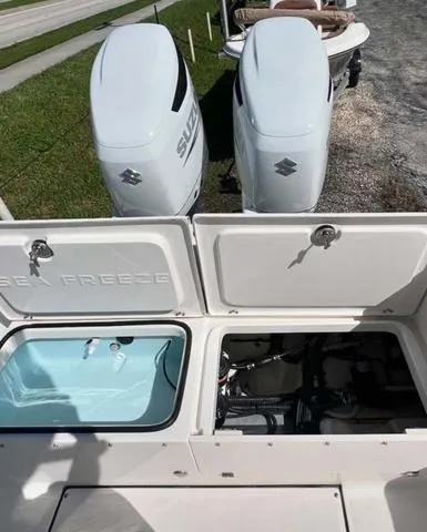 Slide: The Image of 2025 Sea Born LX 26 XSF boat with dual Suzuki outboard engines. - 10