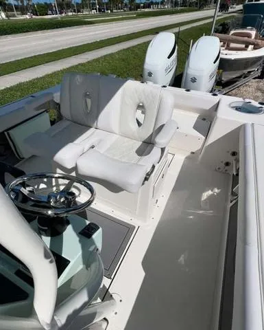 Slide: The Image of 2025 Sea Born LX 26 XSF boat interior with dual engines and steering wheel. - 11