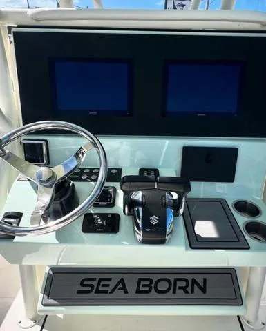 Slide: The Image of 2025 Sea Born LX 26 XSF boat dashboard with dual screens and controls. - 8