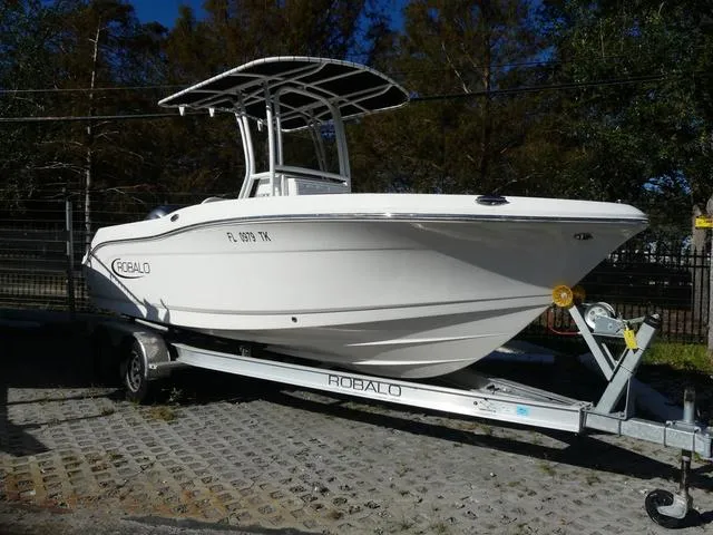 Slide: The Image of 2023 Robalo R200 boat cruising on open water with fishing rods. - 1