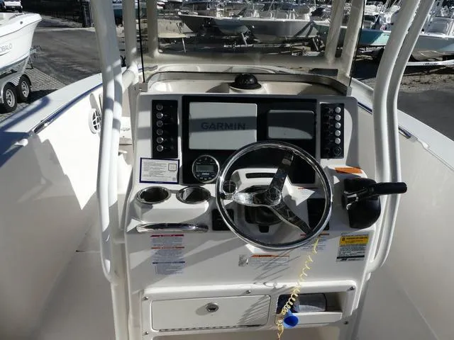 Slide: The Image of 2023 Robalo R200 boat dashboard with Garmin navigation system and steering wheel. - 10