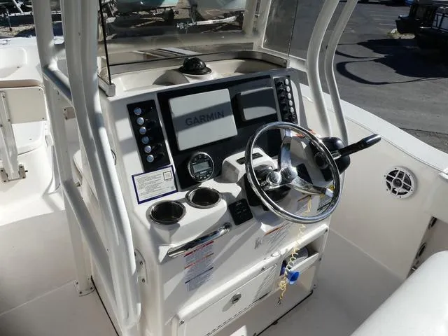Slide: The Image of 2023 Robalo R200 boat console with Garmin navigation system and steering wheel. - 11