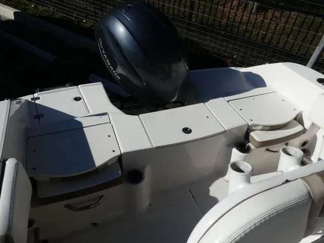 Slide: The Image of 2023 Robalo R200 boat interior with Yamaha engine, featuring seating and storage compartments. - 13