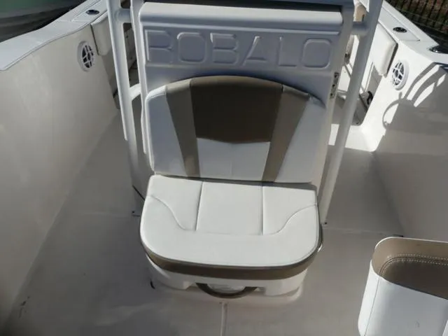 Slide: The Image of 2023 Robalo R200 boat interior with cushioned seating and storage. - 17