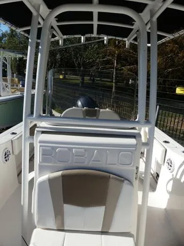 Slide: The Image of 2023 Robalo R200 boat interior with seating and canopy. - 18