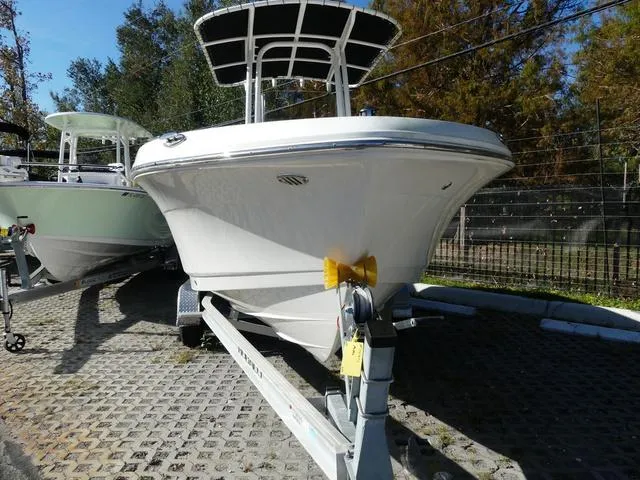 Slide: The Image of 2023 Robalo R200 boat on trailer, parked outdoors. - 2