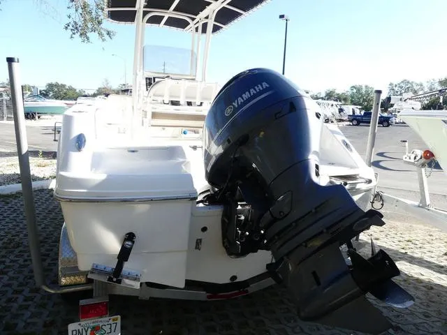 Slide: The Image of 2023 Robalo R200 boat with Yamaha outboard motor, parked on a trailer. - 6