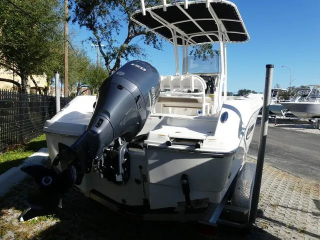 Slide: The Image of 2023 Robalo R200 boat with outboard motor, parked on a trailer. - 7