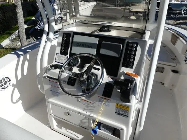 Slide: The Image of 2023 Robalo R200 boat dashboard with Garmin navigation system and steering wheel. - 9