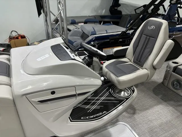 Slide: The Image of 2025 Barletta Corsa 23UC boat interior with sleek captain's chair and modern dashboard. - 13