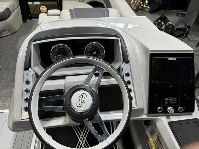 Slide: The Image of 2025 Barletta Corsa 23UC boat dashboard with steering wheel and control panel. - 14