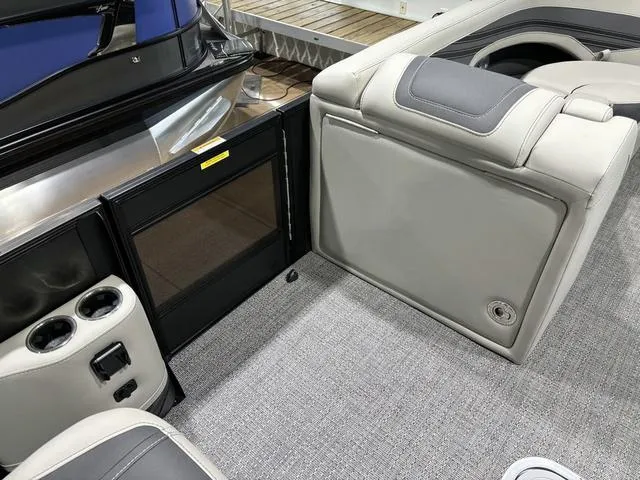 Slide: The Image of 2025 Barletta Corsa 23UC boat interior with gray seating and cup holders. - 16