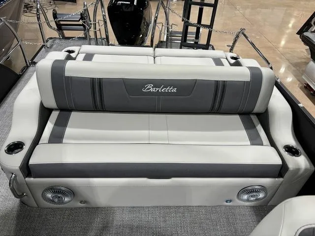 Slide: The Image of 2025 Barletta Corsa 23UC boat interior with plush seating and integrated speakers. - 17