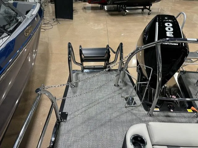 Slide: The Image of 2025 Barletta Corsa 23UC boat with Mercury 300 engine, docked indoors. - 18