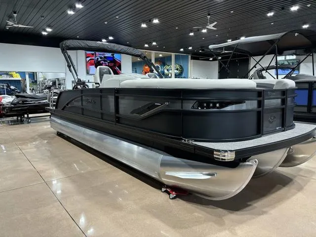 Slide: The Image of 2025 Barletta Corsa 23UC pontoon boat displayed in a showroom. - 3
