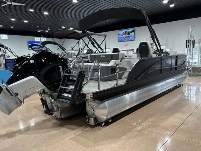 Slide: The Image of 2025 Barletta Corsa 23UC pontoon boat in showroom, sleek design, modern features. - 4