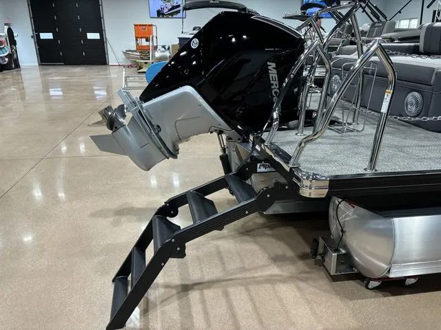 Slide: The Image of 2025 Barletta Corsa 23UC boat with Mercury engine and swim ladder in showroom. - 5