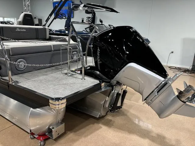 Slide: The Image of 2025 Barletta Corsa 23UC pontoon boat with powerful outboard motor, sleek design. - 6