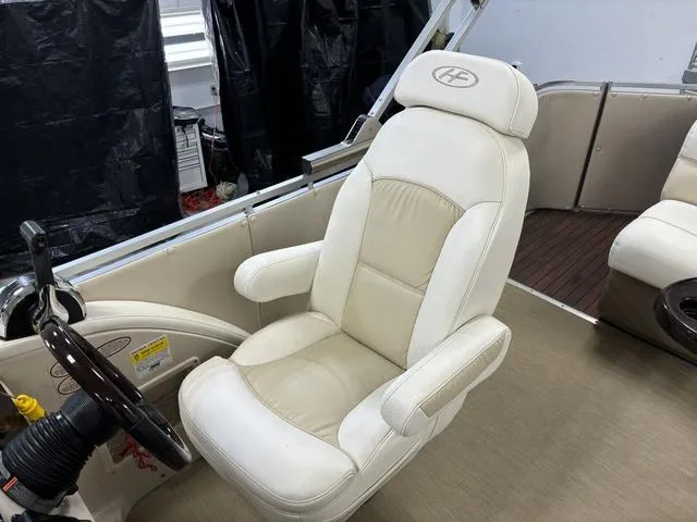 Slide: The Image of Captain's chair in 2013 Harris ROYAL 250 boat, beige upholstery, sleek design. - 20