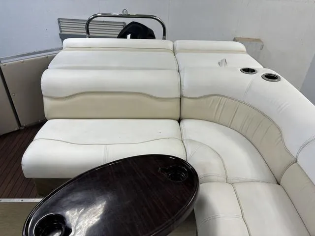 Slide: The Image of 2013 Harris ROYAL 250 boat interior with white seating and wooden table. - 23