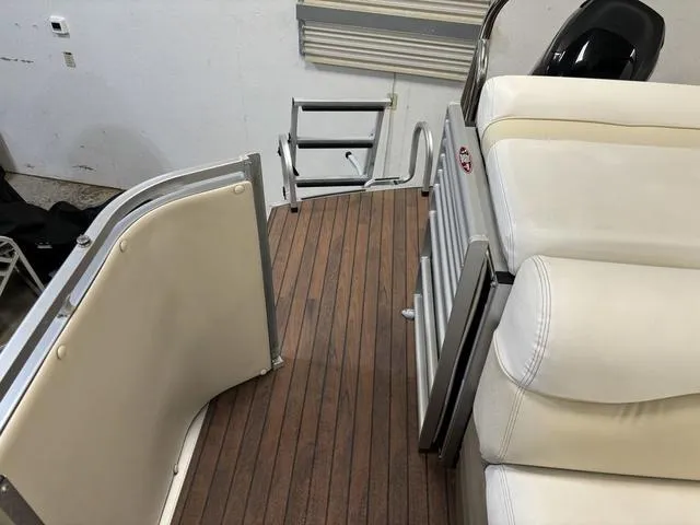 Slide: The Image of Harris ROYAL 250 boat interior, 2013 model, featuring wood flooring and white seating. - 25