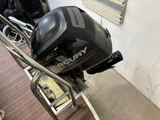 Slide: The Image of Mercury outboard motor on Harris ROYAL 250 boat, 2013 model, in a garage setting. - 28