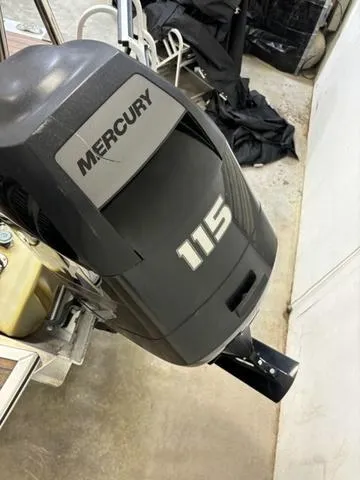 Slide: The Image of Mercury 115 outboard motor on 2013 Harris ROYAL 250 boat in garage. - 29