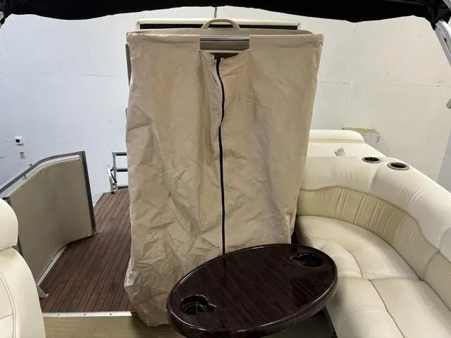 Slide: The Image of Harris ROYAL 250 boat interior with beige cover and wooden table, 2013 model. - 30