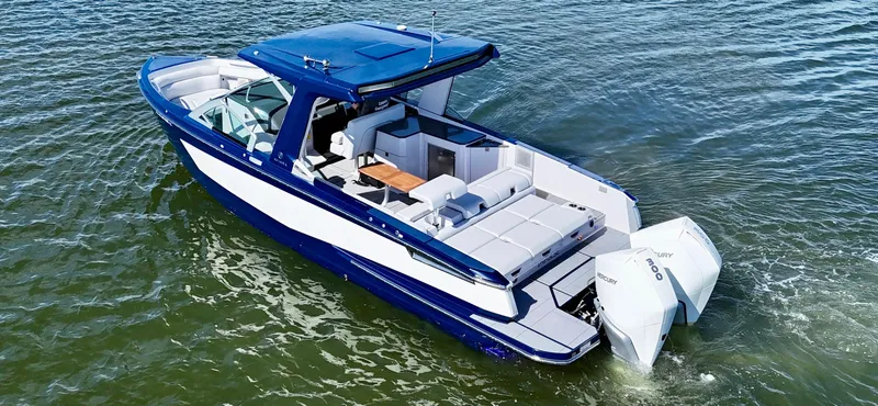 The Image of 2022 Aviara AV 32 Outboard boat cruising on water, featuring sleek design and powerful engines. - 0