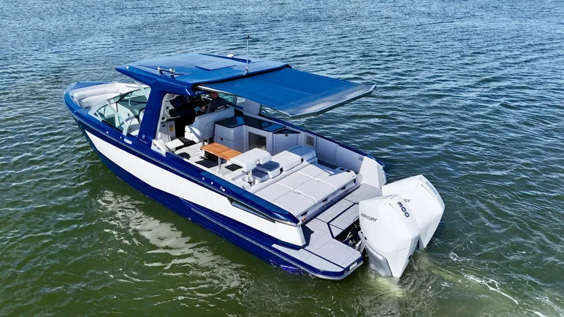 Slide: The Image of 2022 Aviara AV 32 Outboard boat cruising on open water. - 10