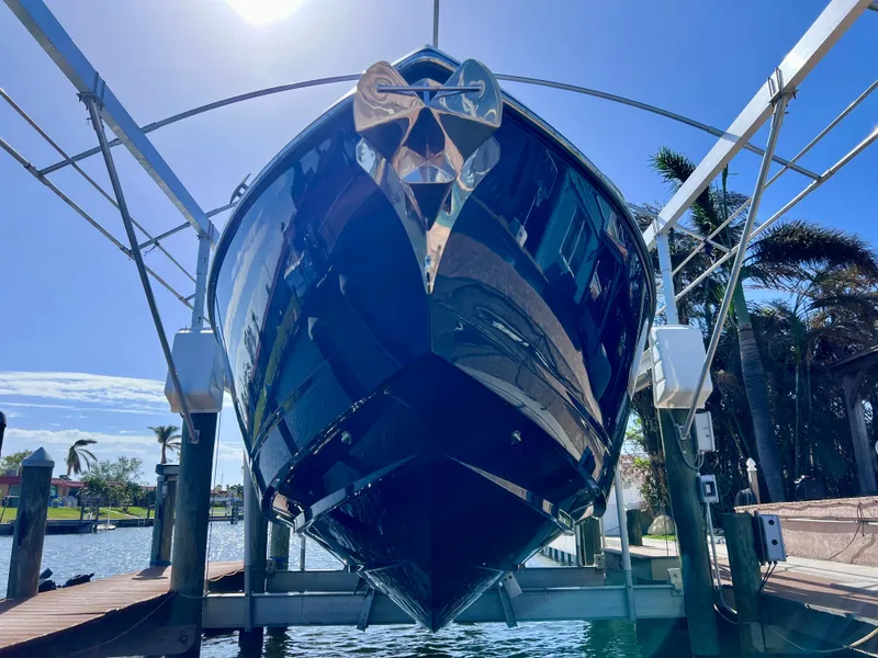 Slide: The Image of 2022 Aviara AV 32 Outboard boat on lift under clear blue sky. - 15