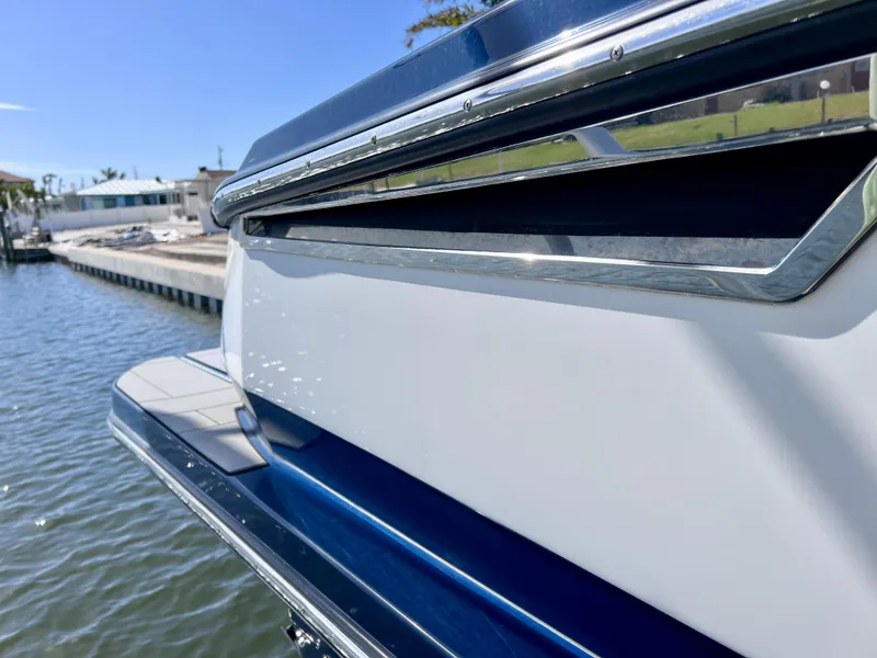 Slide: The Image of 2022 Aviara AV 32 Outboard boat docked by the water. - 18