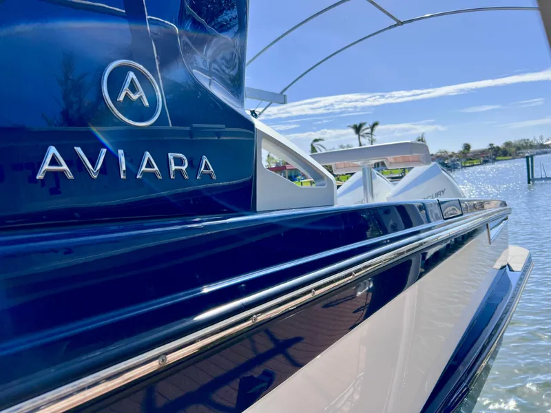 Slide: The Image of 2022 Aviara AV 32 Outboard boat on water, sleek design, sunny day. - 19