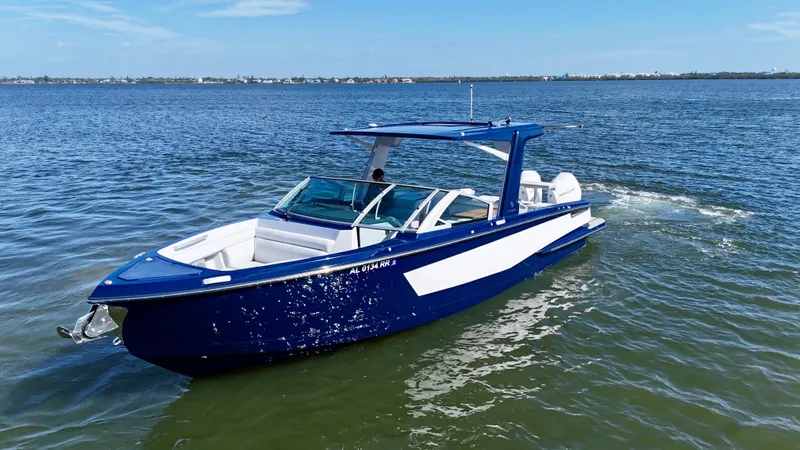 Slide: The Image of 2022 Aviara AV 32 Outboard boat cruising on open water. - 2