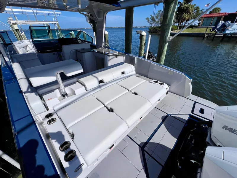 Slide: The Image of 2022 Aviara AV 32 Outboard boat with spacious seating and modern design by the water. - 25