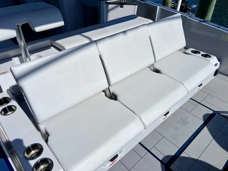 Slide: The Image of 2022 Aviara AV 32 Outboard boat with white cushioned seating and cup holders. - 29